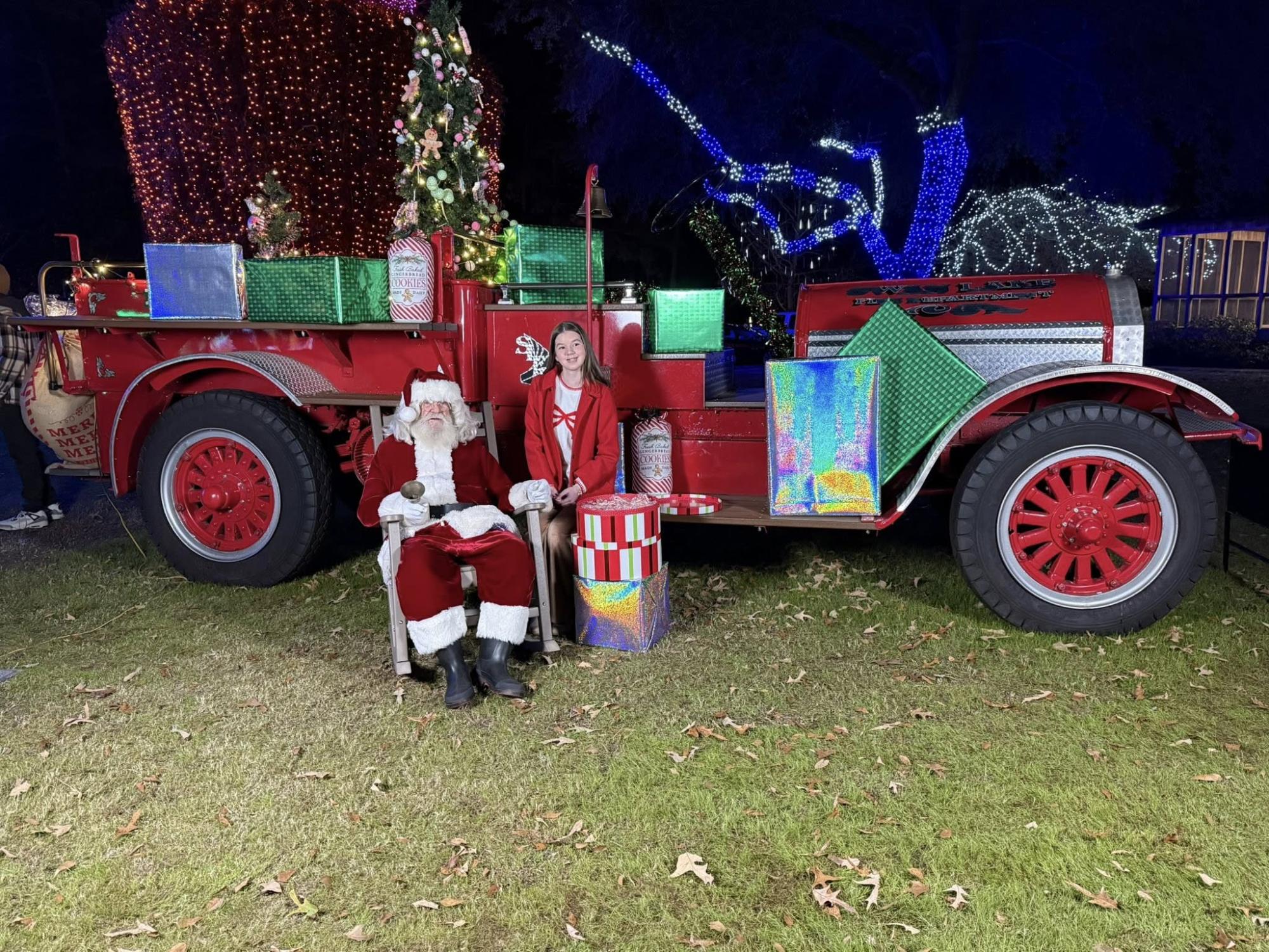 Santa poses with a visitor in front of the 1924 Fire Truck.